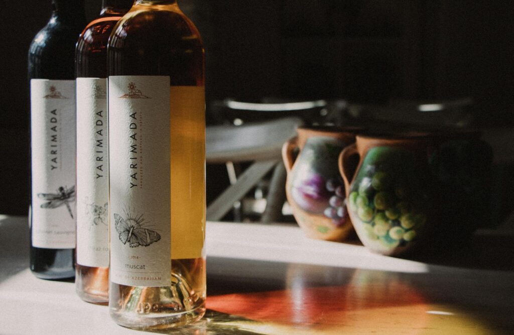 Yarimada wine bottles with minimalist illustrated labels in sunlight.