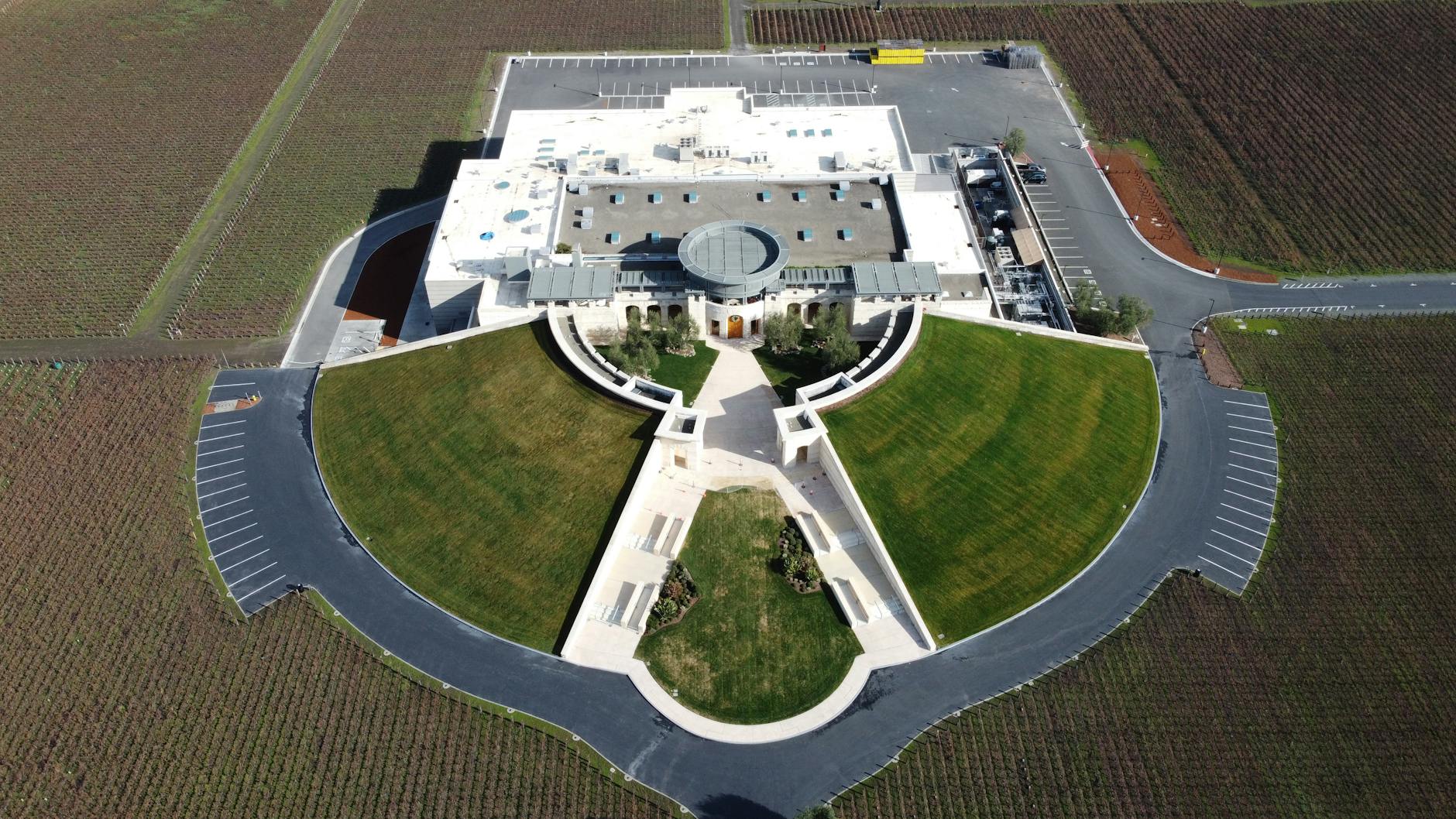 Aerial view of a California winery complex surrounded by vineyards.